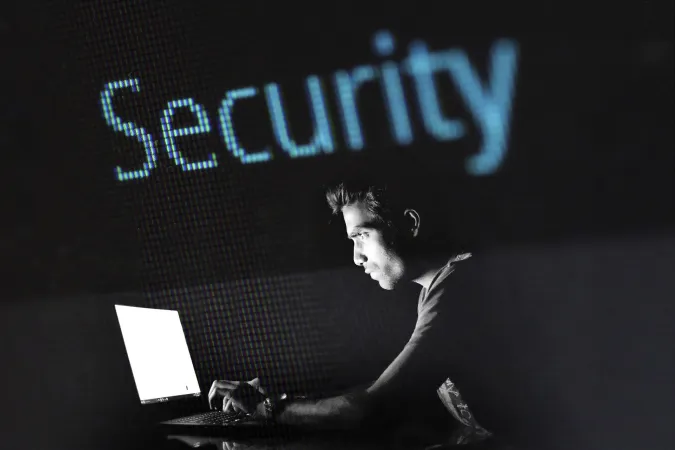 Photo of a hacker using a laptop